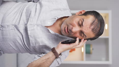 Vertical-video-of-Man-getting-bad-news-on-the-phone-gets-upset.